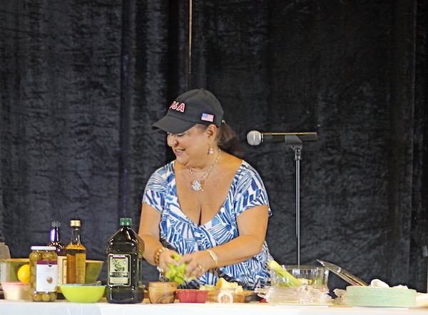 A woman doing a cooking demo.