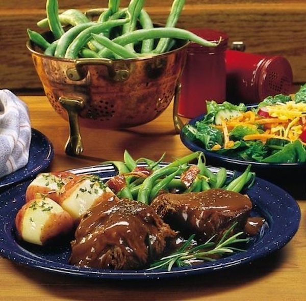 A black plate topped with food and a copper colander of green beans from Autumn Adventures in Branson MO