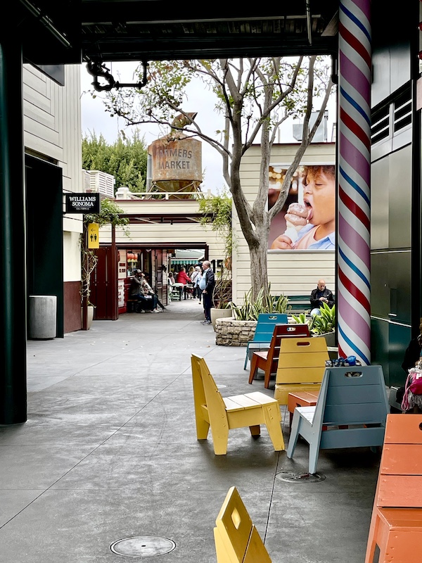 Colorful tables and chairs and additional stores at the Original Farmers Market L.A.