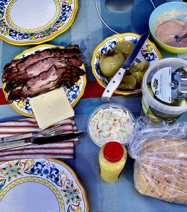 Dining table set with food from Canter's Deli on Fairfax, placemats and plates