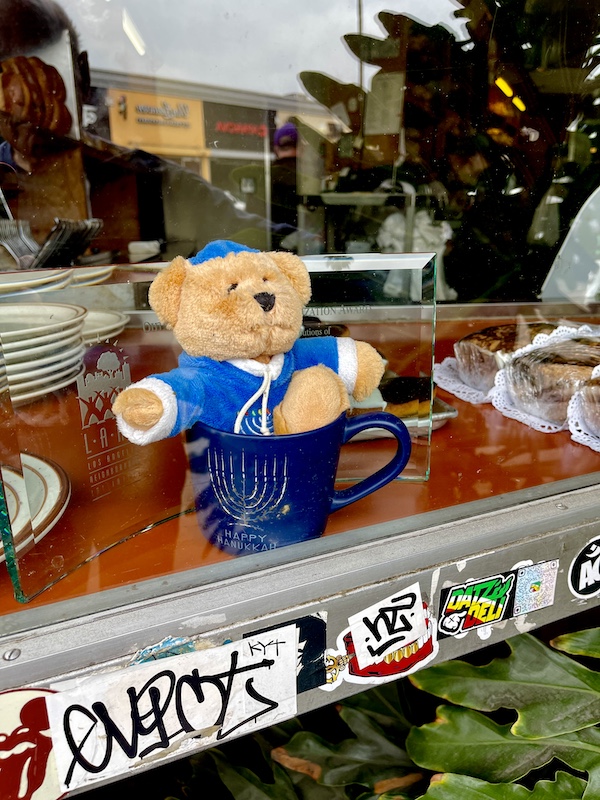 A teddy bear in a coffee mug in the window of Canter's Deli on Fairfax