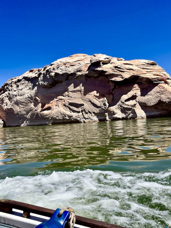 Rock formation that looks like a giant clamshell with smaller shells attached at Spectacular Lake Powell Utah