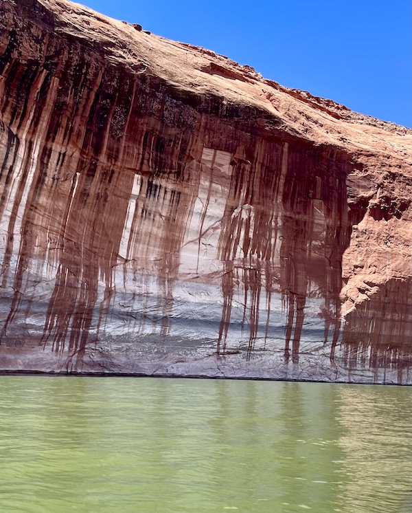 Stripes and rusty drips on a rock formation by the lake.