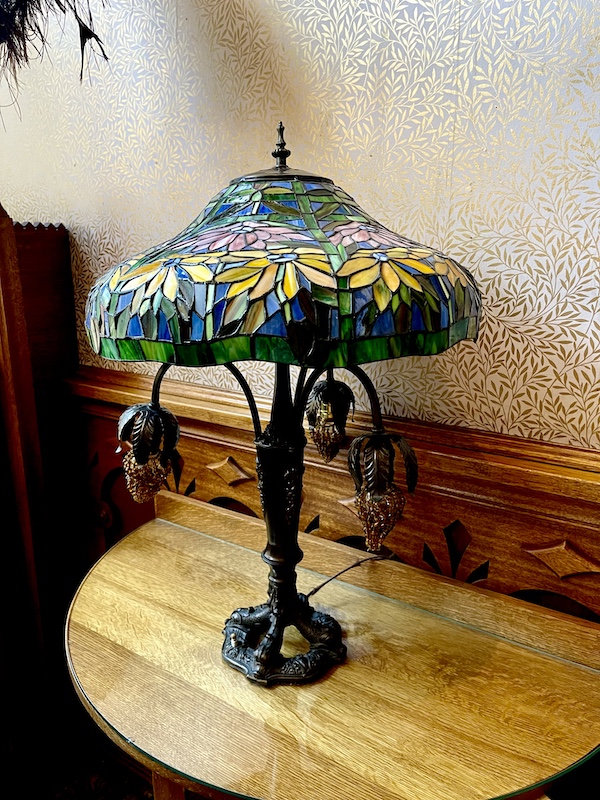 A colorful Tiffany lamp with hanging glass grape clusters on a table at Strater Hotel Durango Colorado