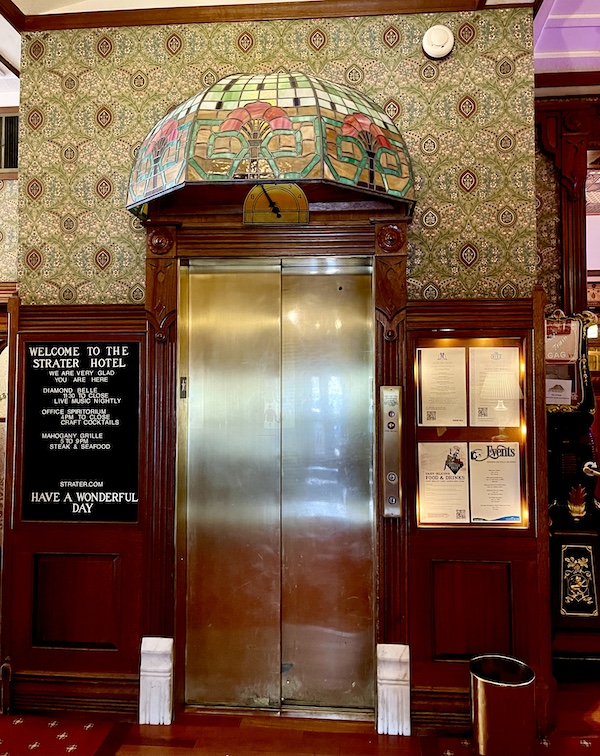 Elevator with stainless steel doors, wood frame and Tiffany glass marquee at the Strater Hotel Durango Colorado