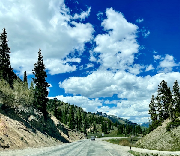 Lots of white cloud and trees along a mountain highway on out Scenic Drive to Silverton and Ouray