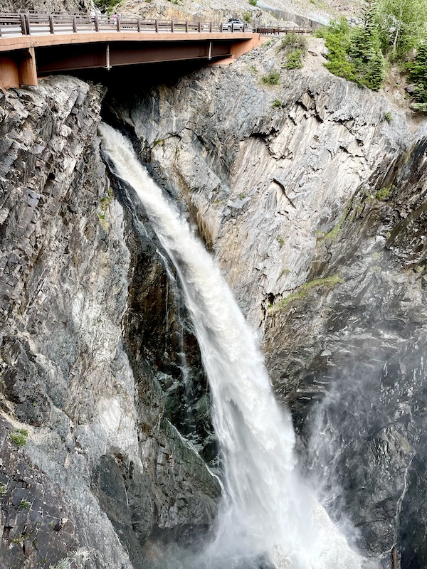 Scenic Drive to Silverton and Ouray revealed a rushing waterfall through a hole in mountain.